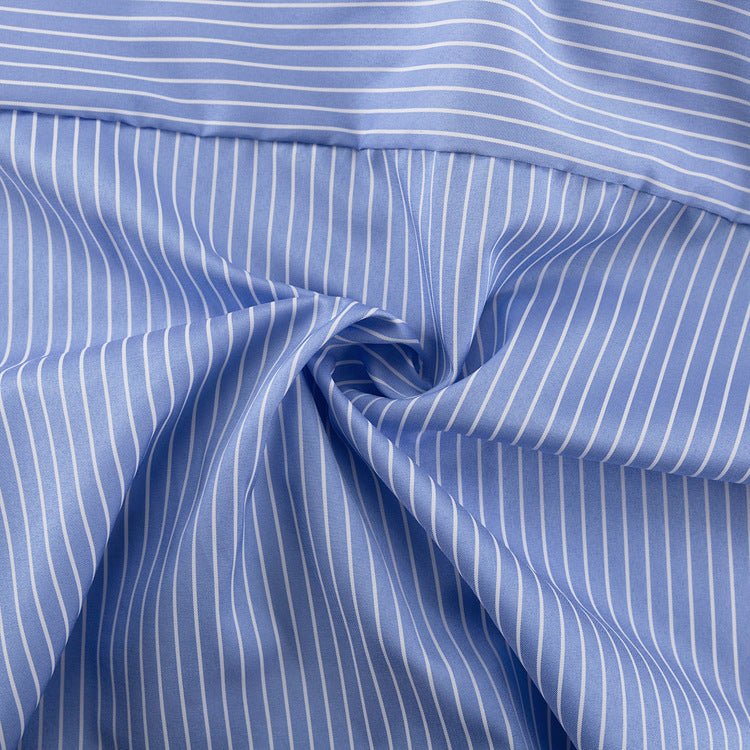 Close-up of the blue and white vertical striped fabric texture, draped