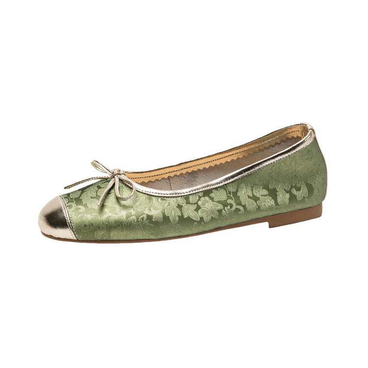 Green floral ballet flat with metallic toe cap and bow, side view on white background