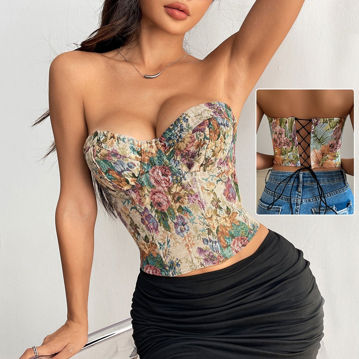 Strapless floral corset top in a dense rose print with a black skirt; inset shows the laced back