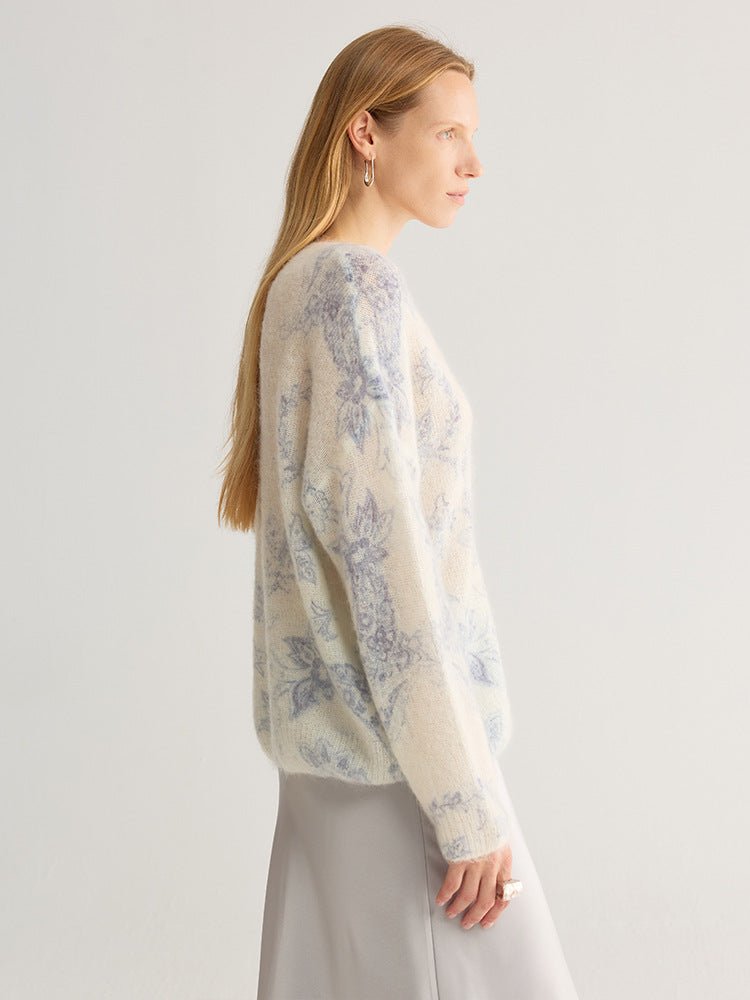 Side view of the blue floral fluffy knit jumper with a loose sleeve and ribbed cuff