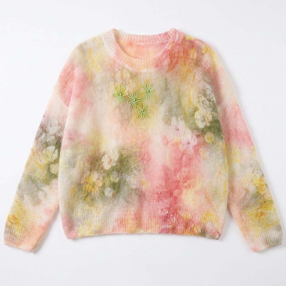 Yellow-pink watercolour jumper laid flat, with green beaded flowers on the chest