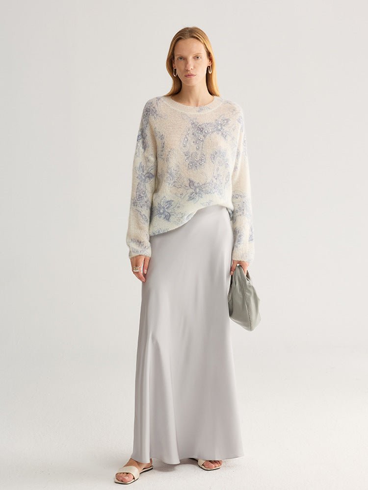 Full-length view of the blue floral jumper worn over a long grey skirt with flat sandals