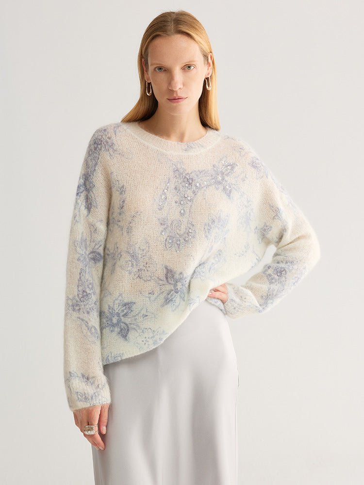 Fluffy floral jumper with blue flowers on ivory, worn by a model with one hand on her hip