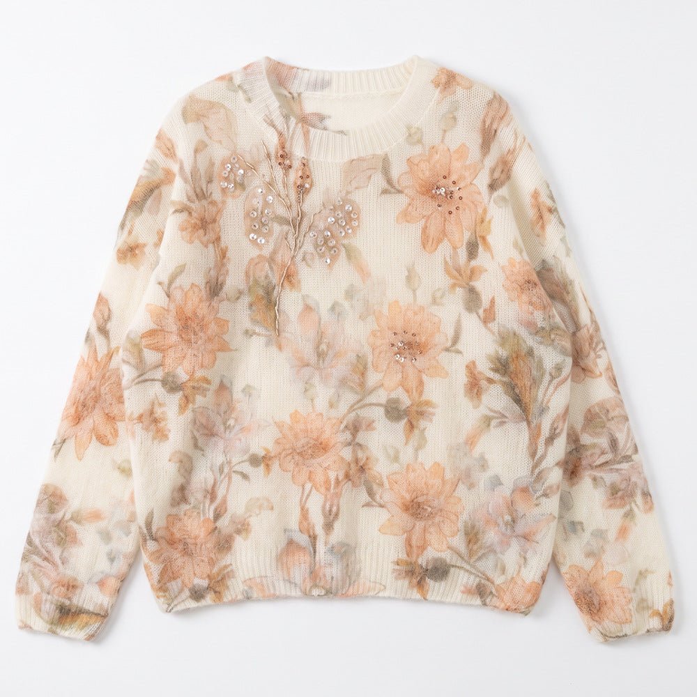Peach floral jumper laid flat, peach flowers on ivory with beads near the neckline