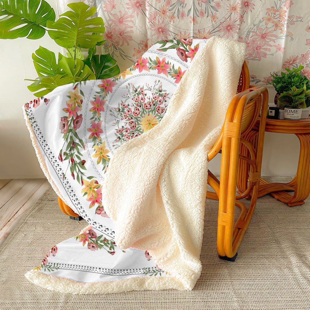 Floral flannel throw with sherpa back over a rattan chair