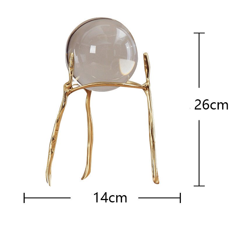 Clear glass ball on the tall gold-tone stand with slim legs, marked 26 cm high and 14 cm wide