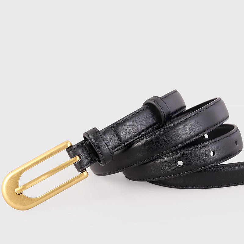 Gold buckle skinny leather belt with sleek metal closure on black cowhide strap - fashion accessory