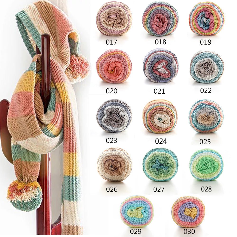 Gradient knitting yarn in cotton and acrylic: striped scarf with pompoms next to the colour chart of the fourteen gradient balls