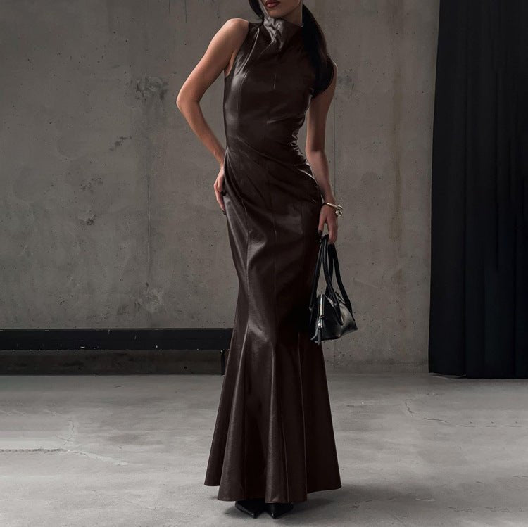 Side view of the fitted brown leather-look dress with a black handbag