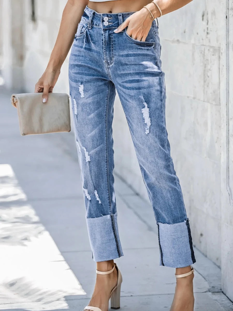 High waist distressed straight leg jeans with vintage fade and rips on dark wash denim fabric