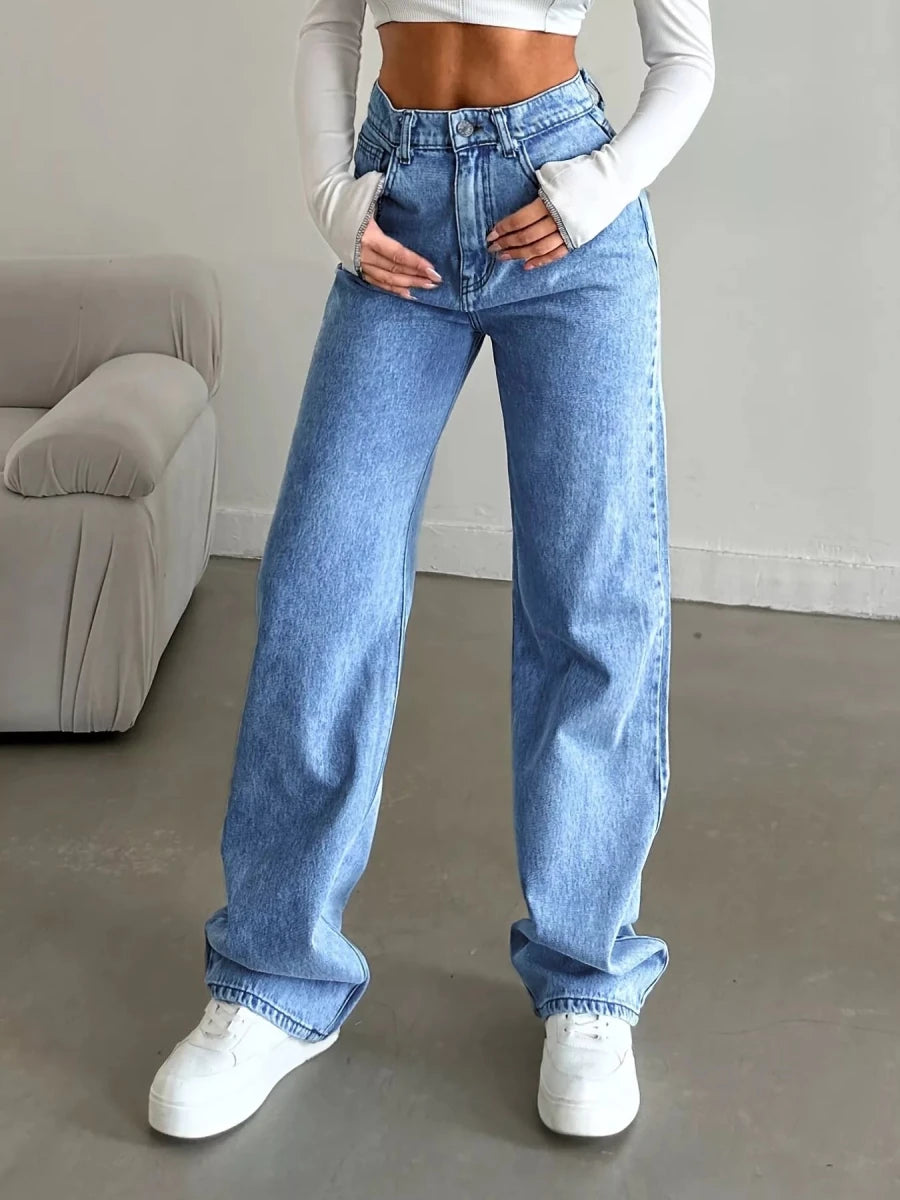 High-waisted wide leg jeans in dark wash stretch denim, model wearing on city street with sneakers and white top