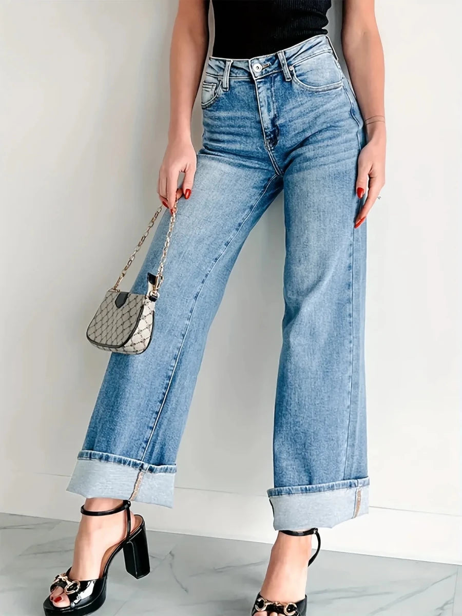 Model wearing high-waisted wide leg jeans in dark wash, showcasing relaxed fit and flattering silhouette