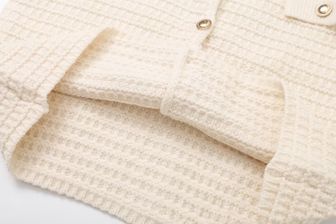 Close-up of the ribbed cuff and the grid texture of the knit