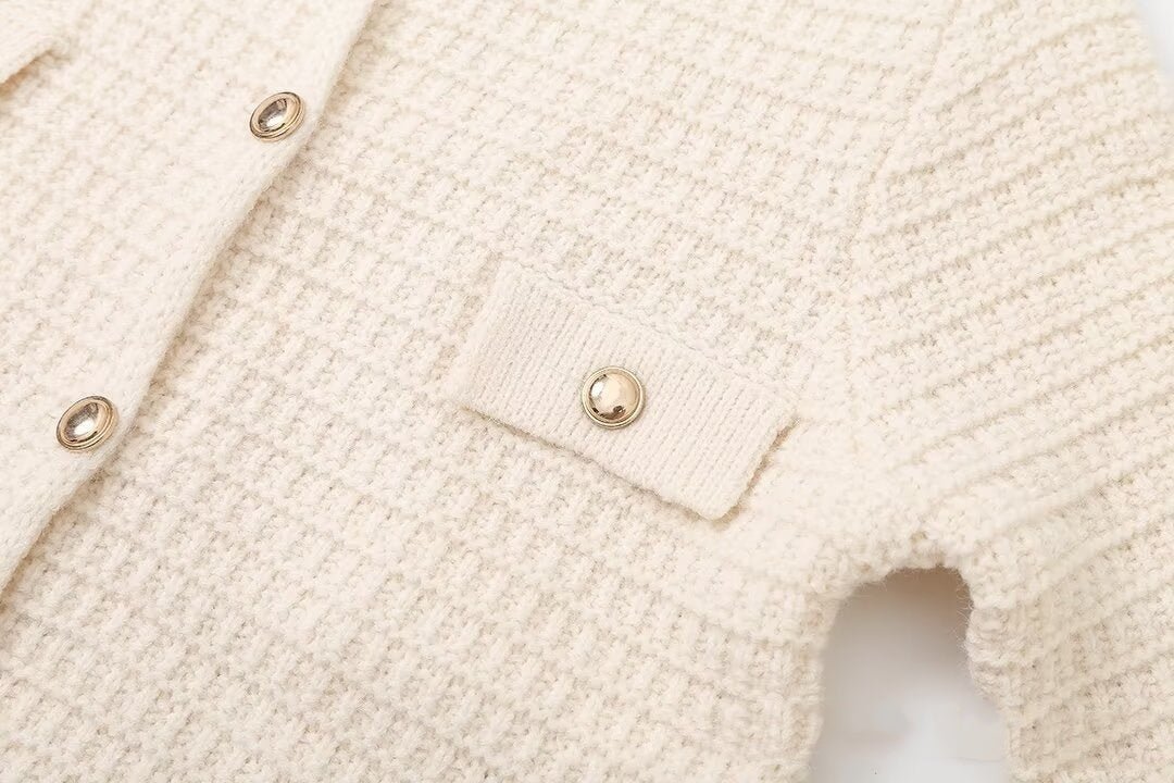 Close-up of a pocket flap with a round gold-tone button