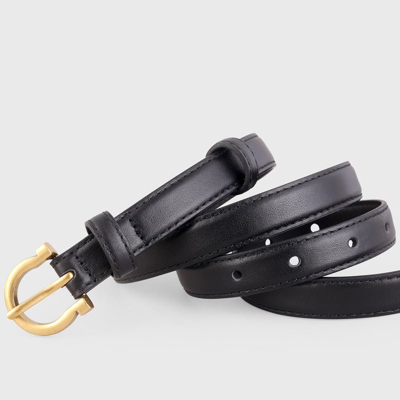 Brown leather belt with gold-tone buckle and adjustable metal prong closure, worn on a model's waist