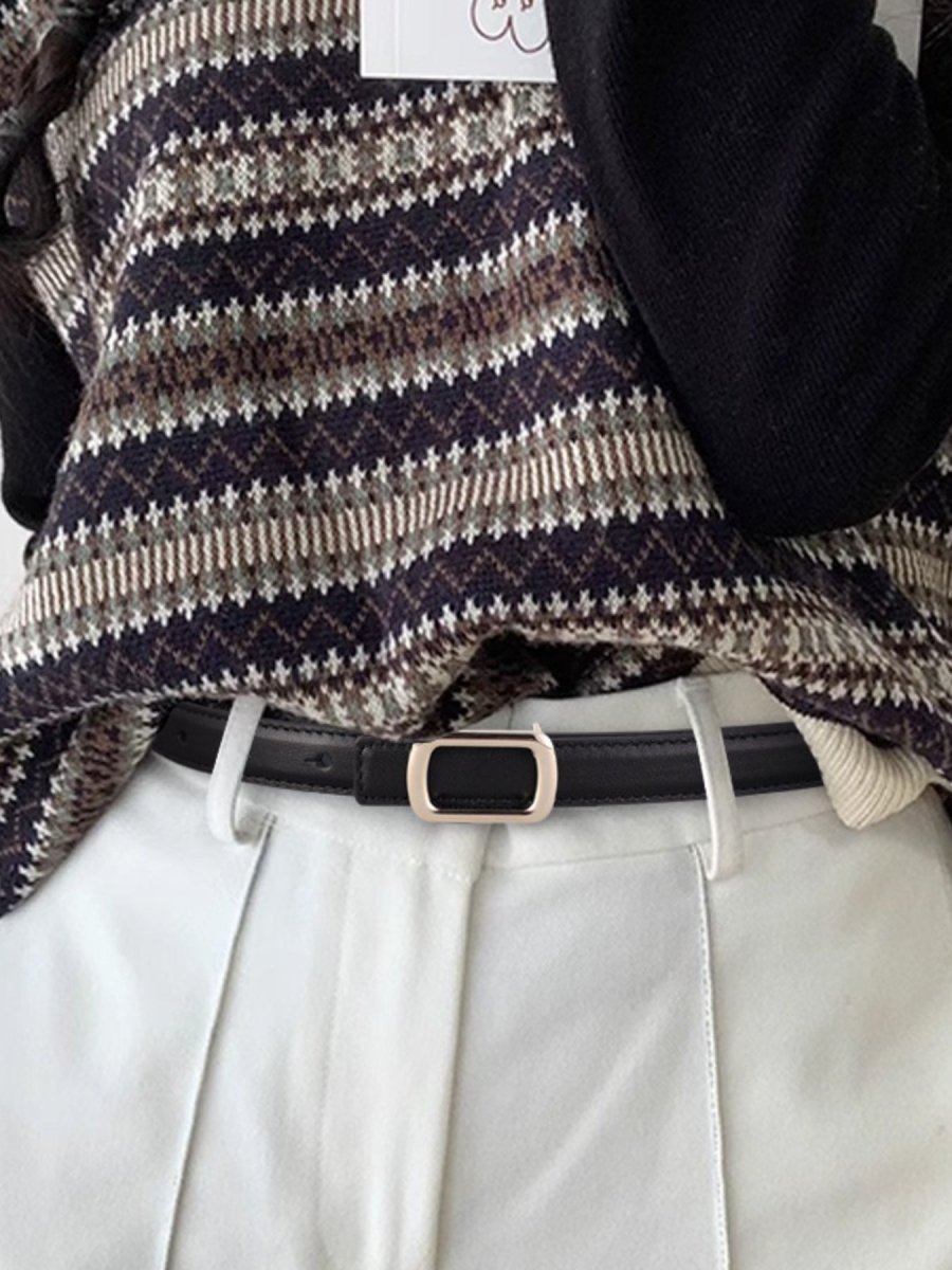 Brown leather skinny belt with brushed metal buckle on black background - Premium cowhide accessory