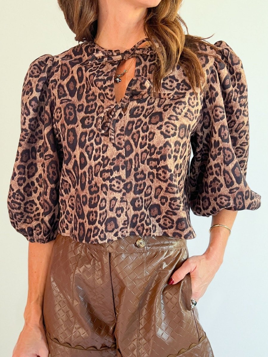 Leopard Bow Tie Puff Sleeve Blouse with dramatic puff sleeves and bow detail in leopard print — bold feminine top