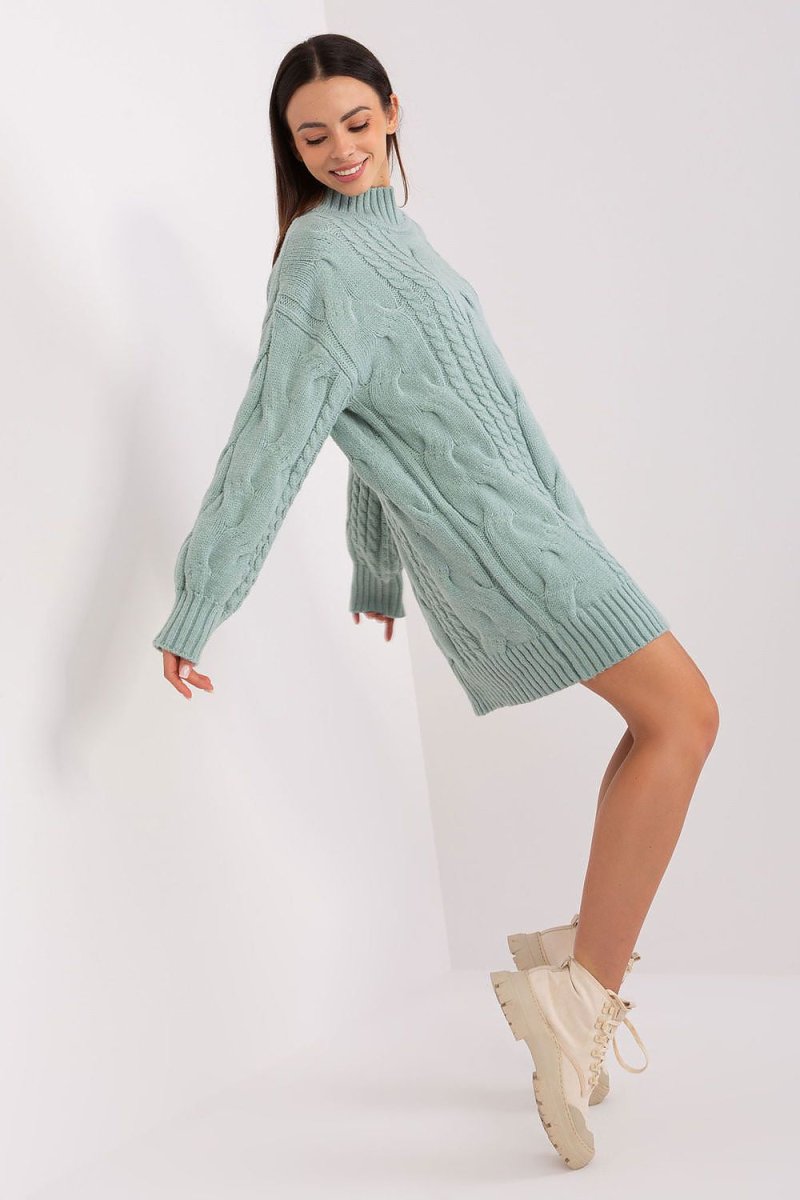 Model wearing AT oversized turtleneck long jumper in green knit fabric with relaxed fit and long sleeves