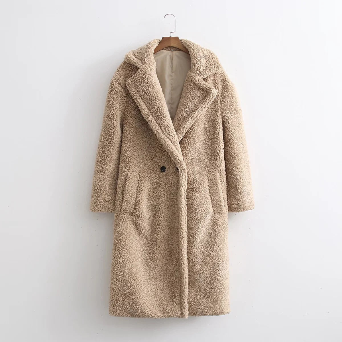 Front of the camel-beige teddy coat showing the slanted hip pockets