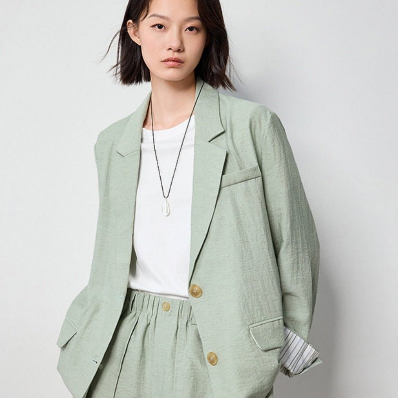 Sage green linen-look blazer over a white top