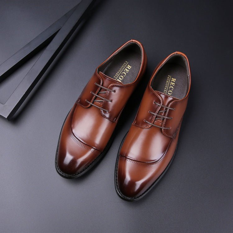 Pair of brown cap-toe lace-up shoes seen from above on a dark background