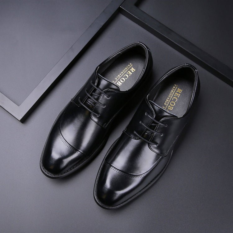 Pair of black cap-toe lace-up shoes seen from above, RECOB printed on the insoles