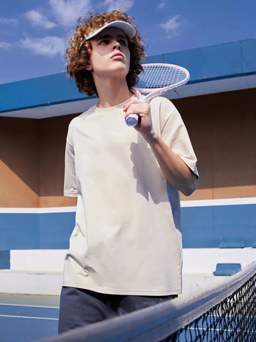 Man wearing light grey quick-dry crew neck t-shirt, casual fit, breathable cotton blend fabric