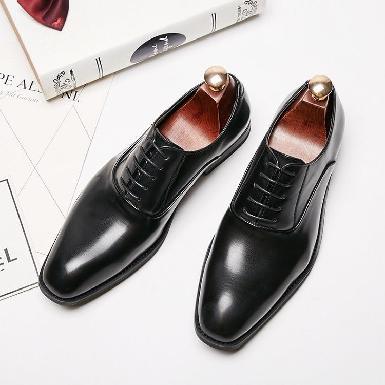 Black lace-up shoes with shoe trees inside, seen from above