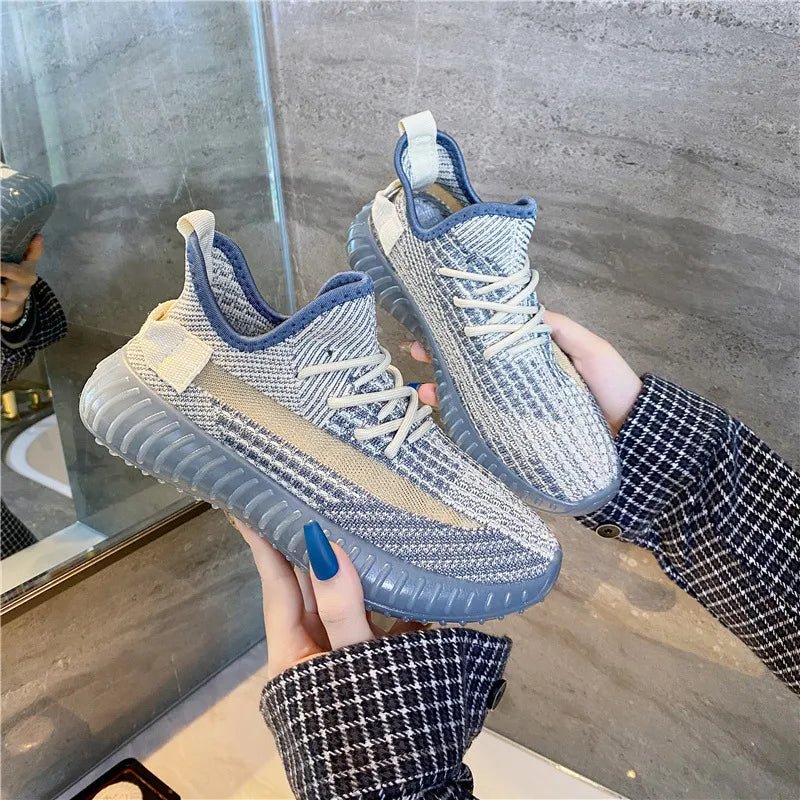 White mesh lace-up platform athletic sneakers on urban street background – breathable running shoes with rubber sole