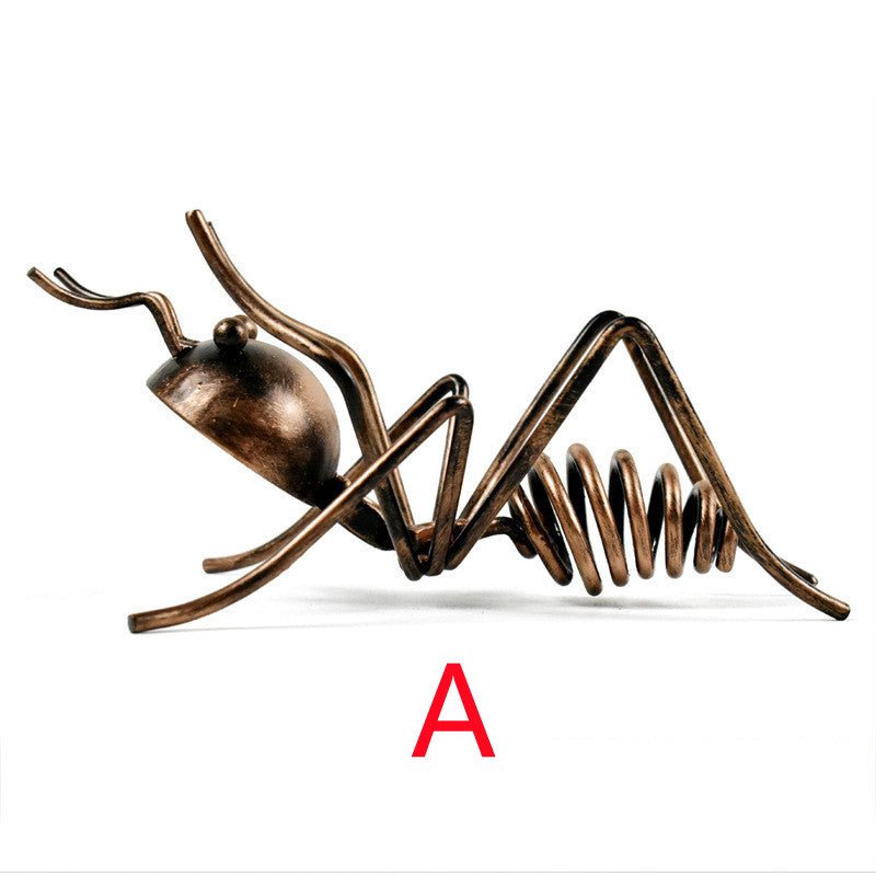 Bronze-coloured metal ant wine bottle holder in pose A, lying low, marked with a red letter A
