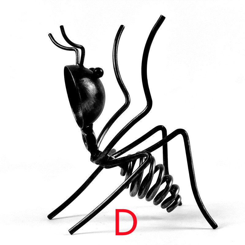 Black metal ant in pose D, reared up on its hind legs, marked with a red letter D