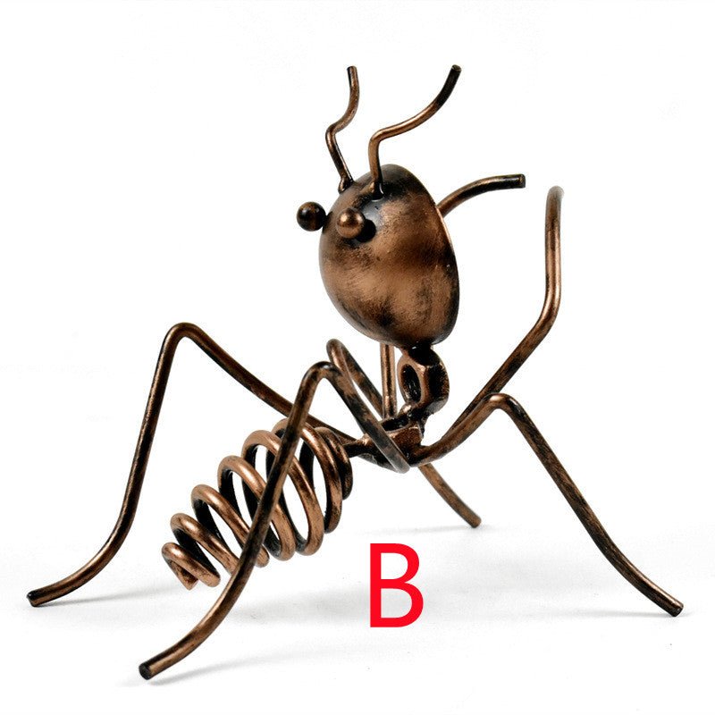 Bronze-coloured metal ant in pose B, standing with its head raised, marked with a red letter B