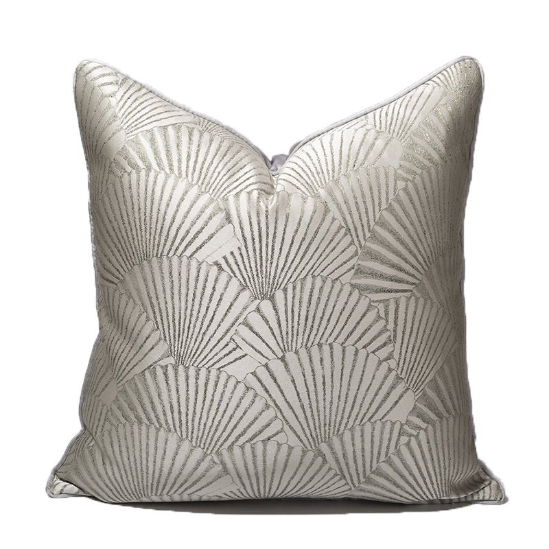 Pale silver cushion with a woven shell pattern