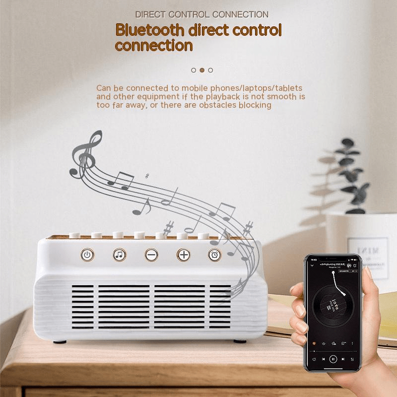 White Bluetooth speaker with eight sliders on a wood-look top, on a sideboard next to a phone playing music