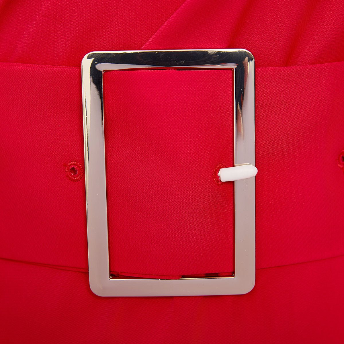 Close-up of the silver-tone rectangular belt buckle on the red self-belt