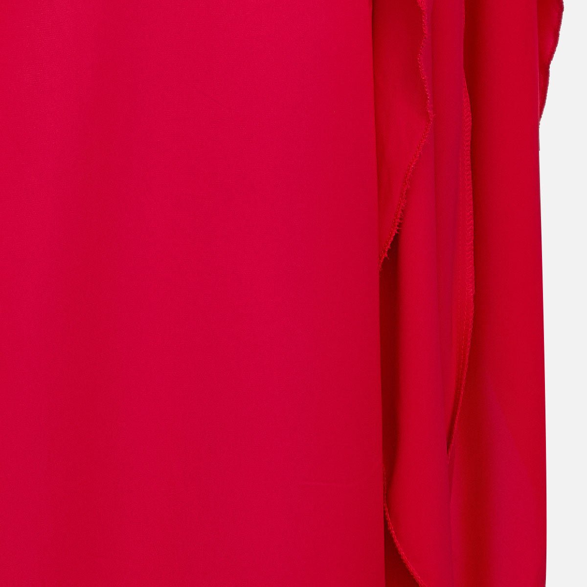 Close-up of the red fabric and the edge of the draped sleeve