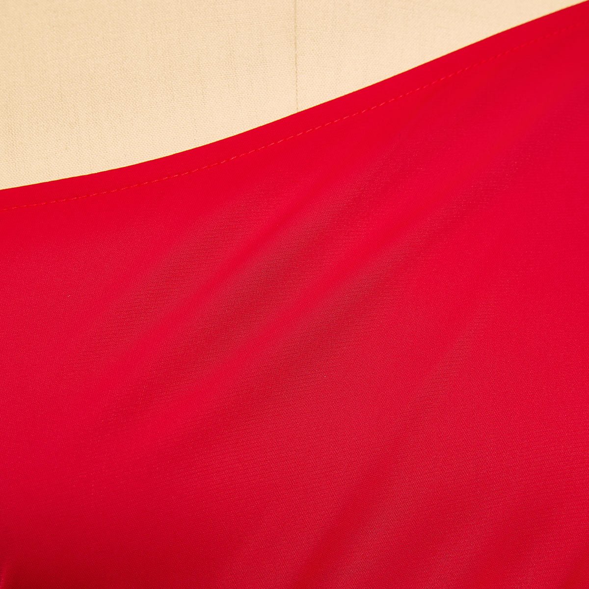 Close-up of the smooth red fabric at the shoulder line