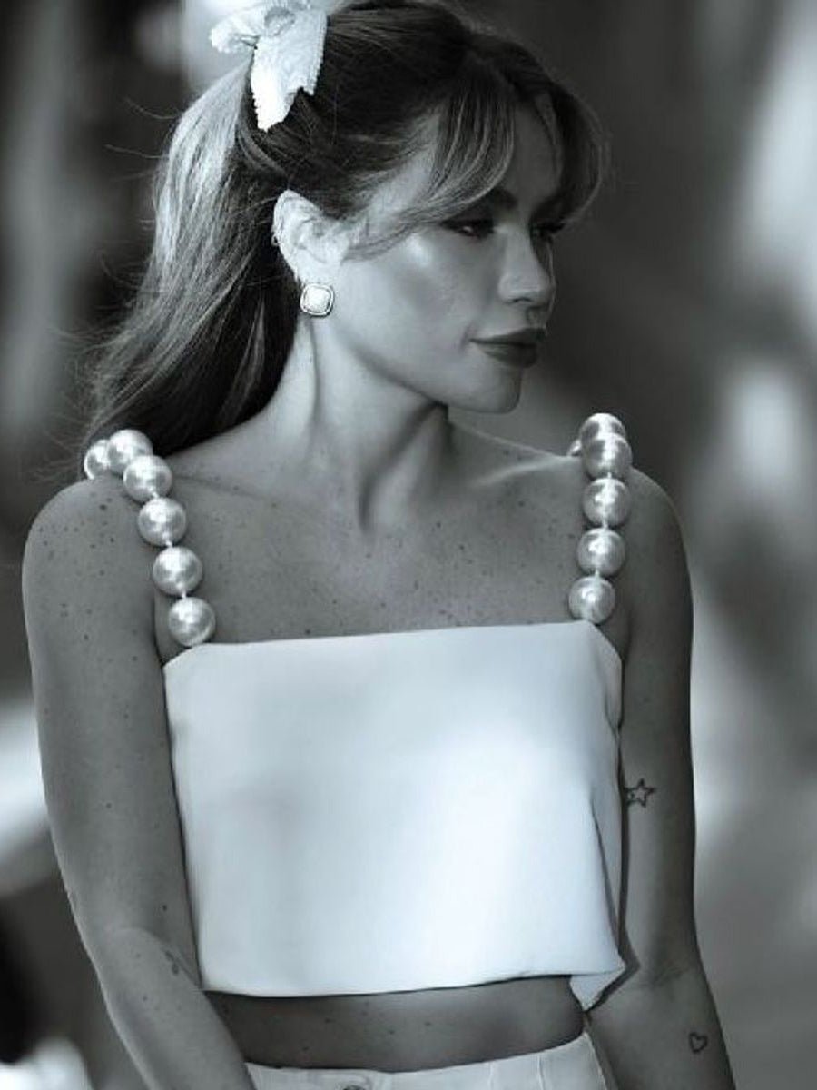 Black and white photo of a woman wearing the bandeau top with bead straps