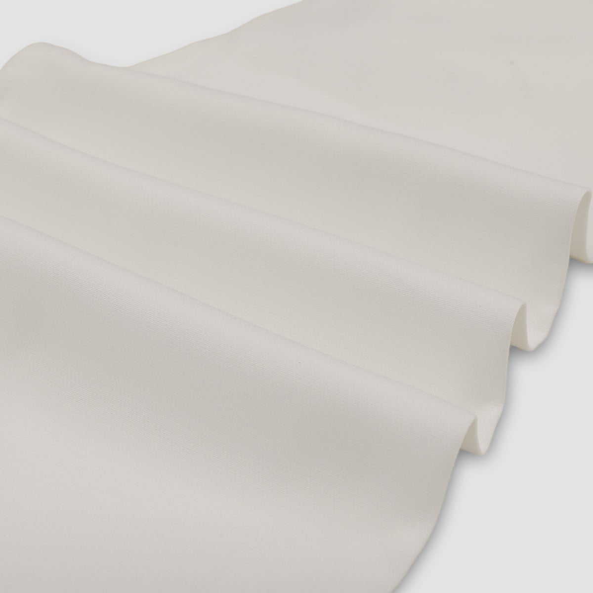 Close-up of the smooth white fabric folded in soft waves