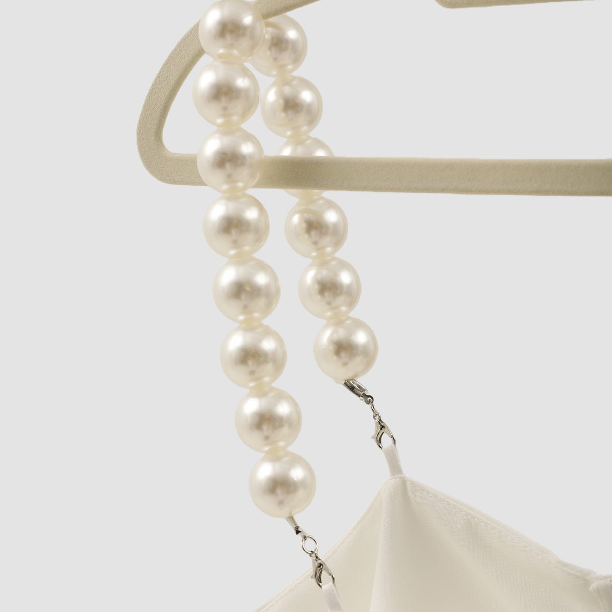 Bead straps hanging from a hanger, with the small clasps at the ends