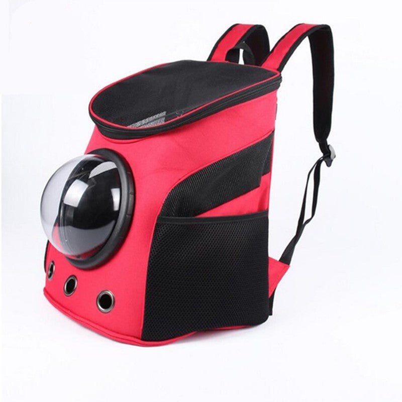 Red pet carrier backpack seen from the side, with a clear dome window, black mesh panels and two shoulder straps