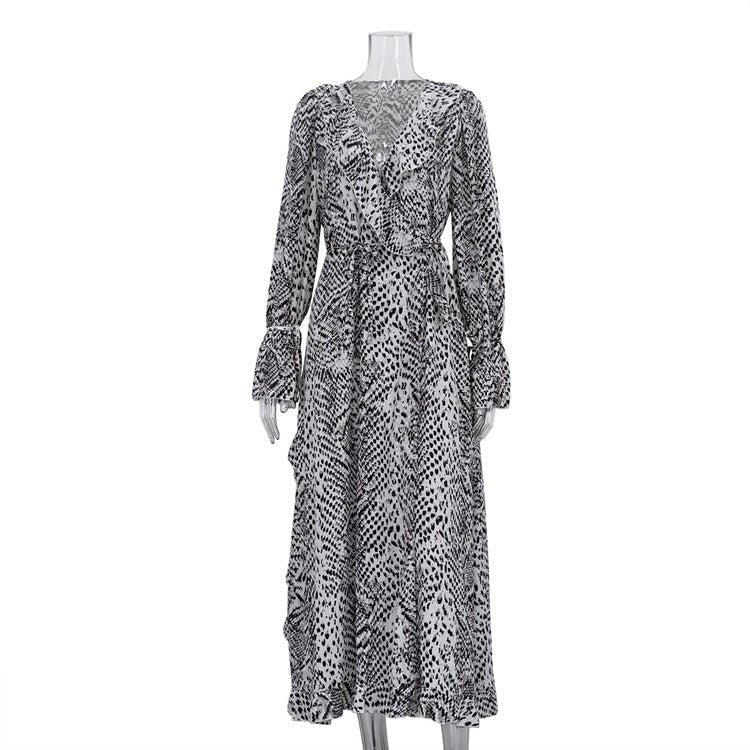 Front of the black and white print maxi dress on a mannequin, with wrap ruffle and cuffs