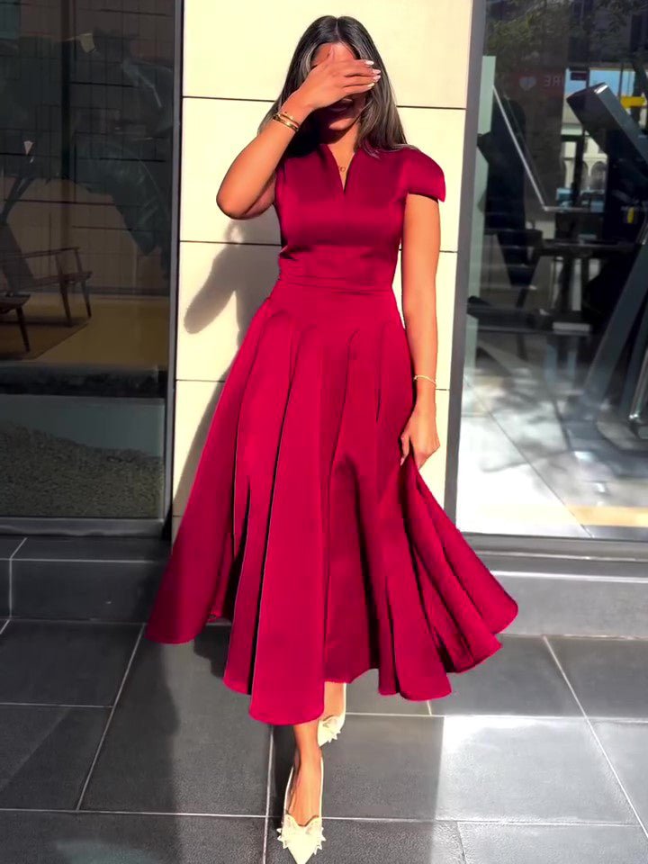 Red midi dress with cap sleeves and fitted bodice, hem just above the ankle