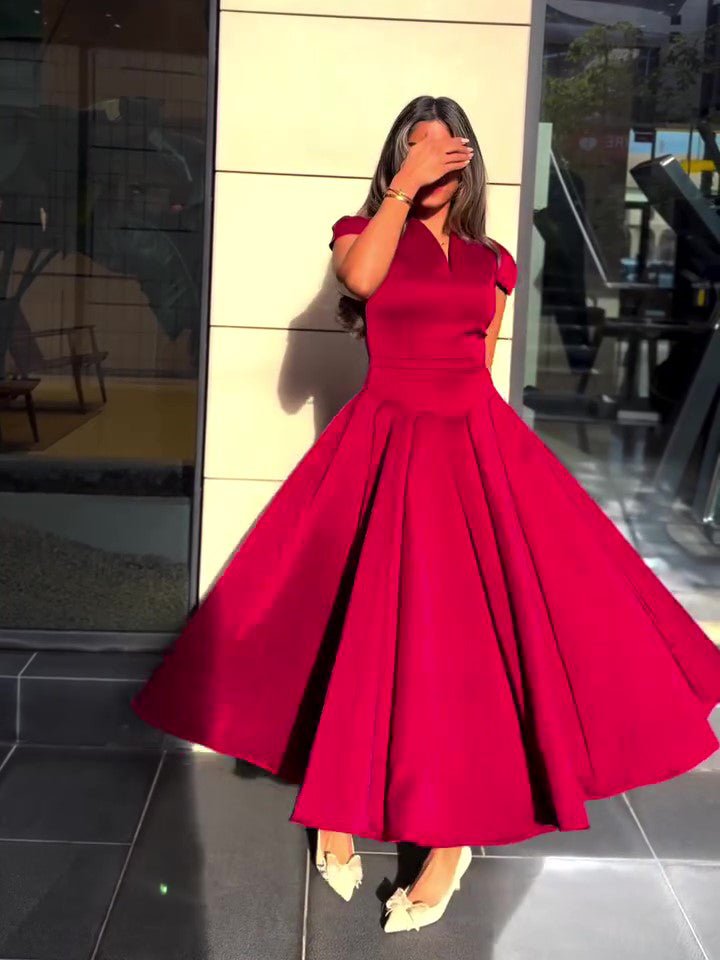 Red dress from the front with the full skirt spread out, worn with cream heels