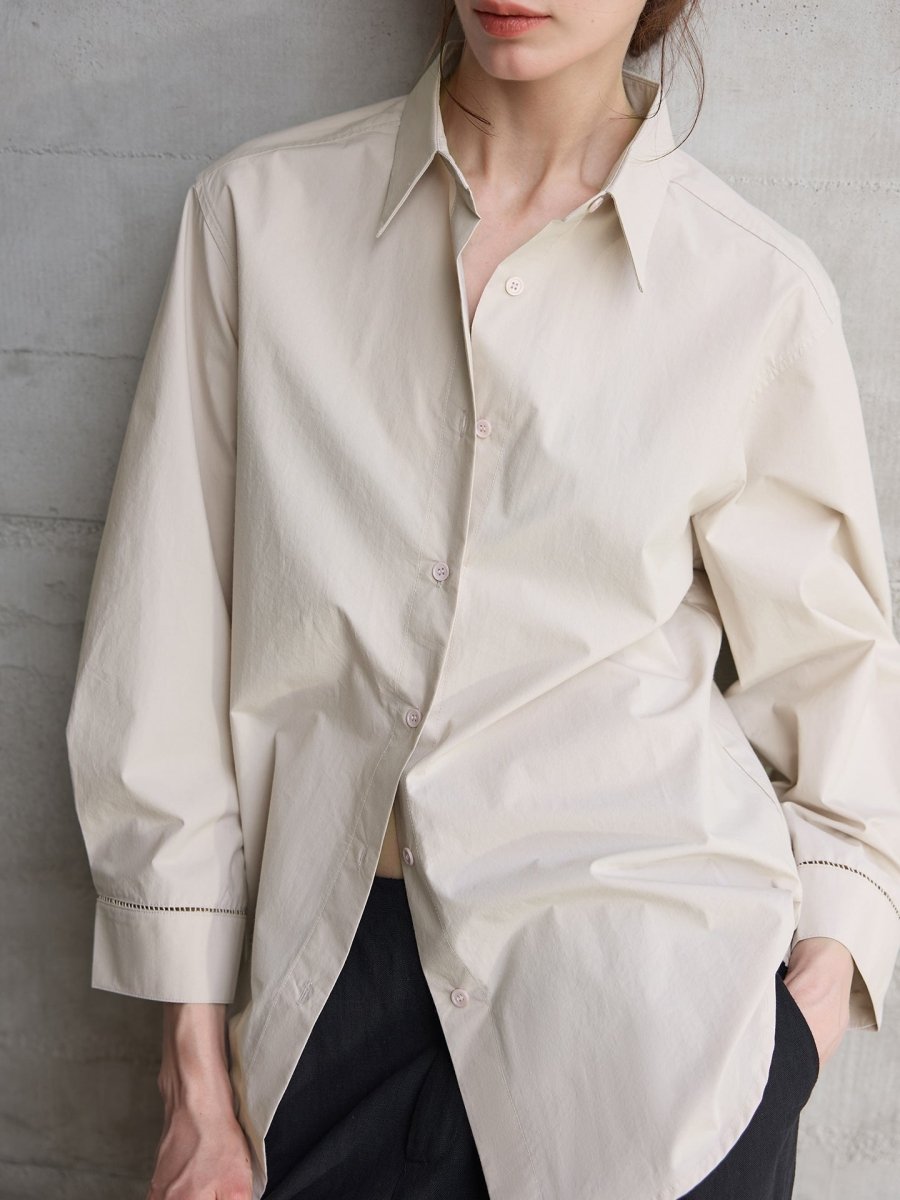 Light grey shirt half-buttoned, close view of collar and cuff stitching