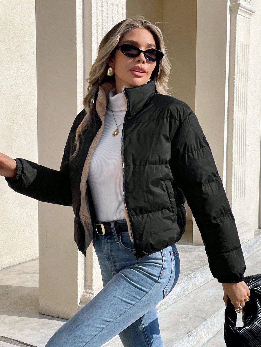 Side view of the cropped black puffer jacket with stand collar on a model with sunglasses