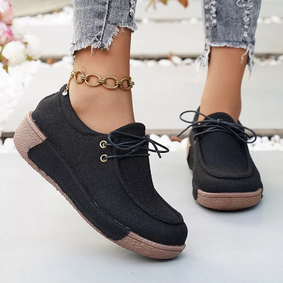 Round Toe Lace-Up Sneakers in black canvas with flat rubber sole and minimalist design