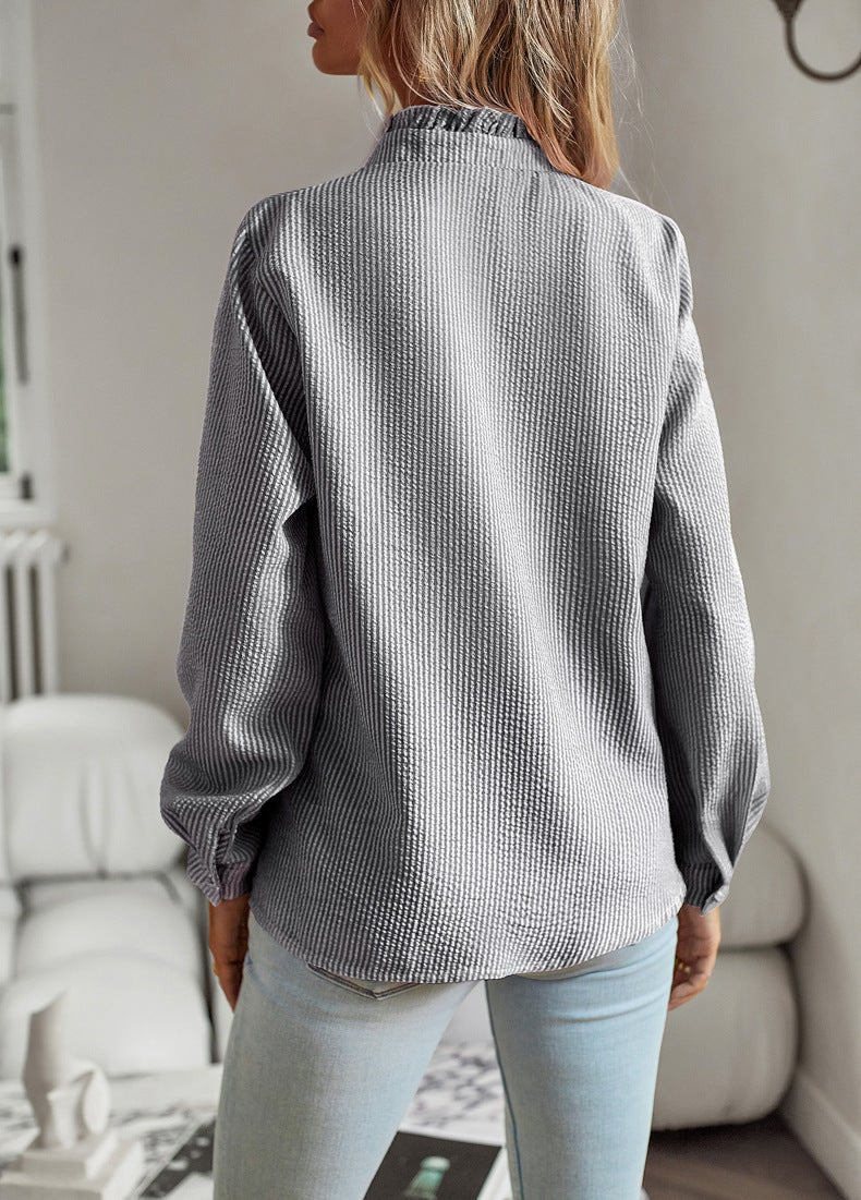 Back view of the black stripe blouse with gathered sleeves at the cuff