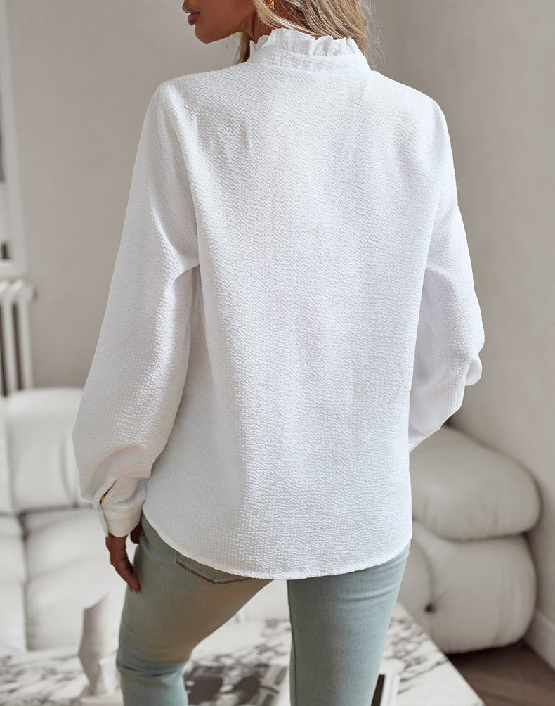 Back view of the white blouse with ruffled stand collar and crinkle texture