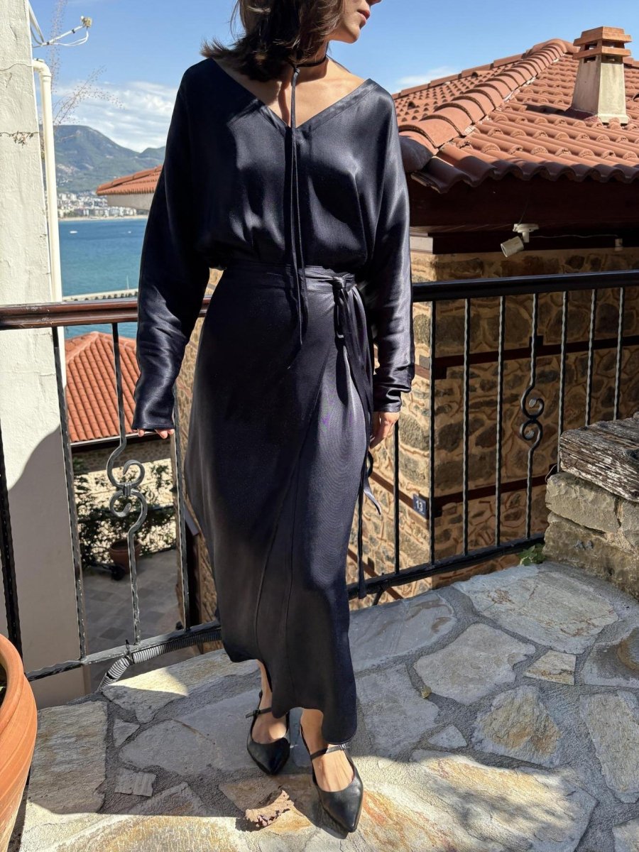 Navy maxi dress on a terrace with a sea view, thin tie at the neckline